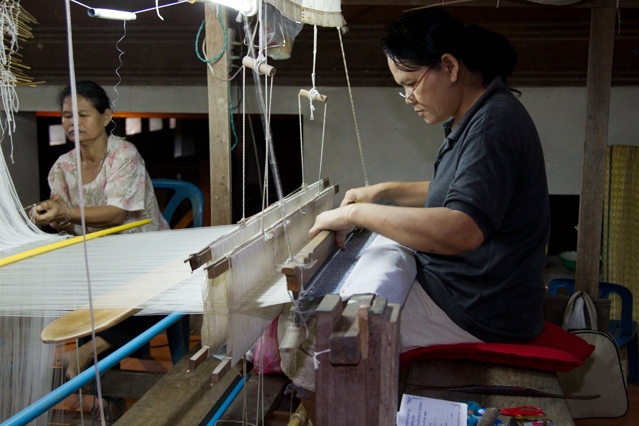 Traditional Isan silk weaving at a wooden loom