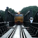 Train crossing a bridge over the River Kwai in Kanchanaburi, Thailand