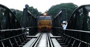 Train crossing a bridge over the River Kwai in Kanchanaburi, Thailand