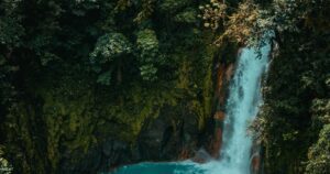 Waterfall cascading into a turquoise pool in Khao Yai rainforest, Thailand