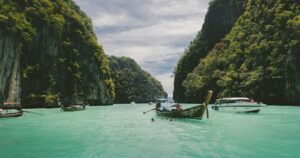 Wooden longtail boats on turquoise sea near Koh Yao Noi, Thailand