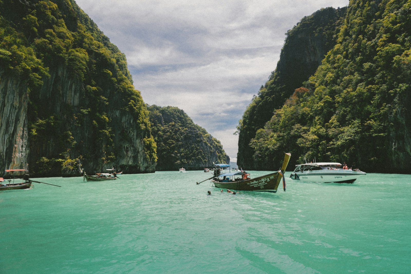 Wooden longtail boats on turquoise sea near Koh Yao Noi, Thailand