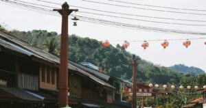 Lantern-lined street with shops in Lampang old town, Thailand