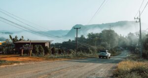 Car driving on a misty mountain road in Mae Hong Son, Thailand